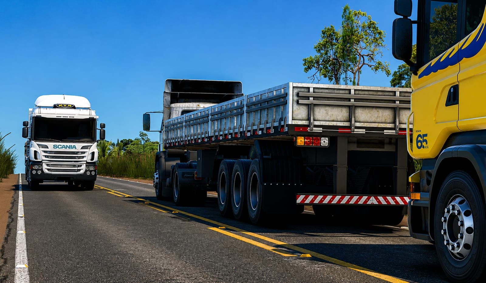 Scania amarelo com graneleira de alumínio e Scania branco na rodovia